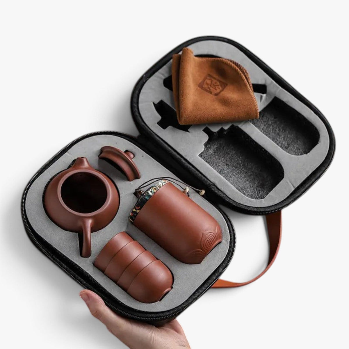 Roselva traditional travel tea set with brown ceramic teapot, cups, and storage jar in a protective travel case.
